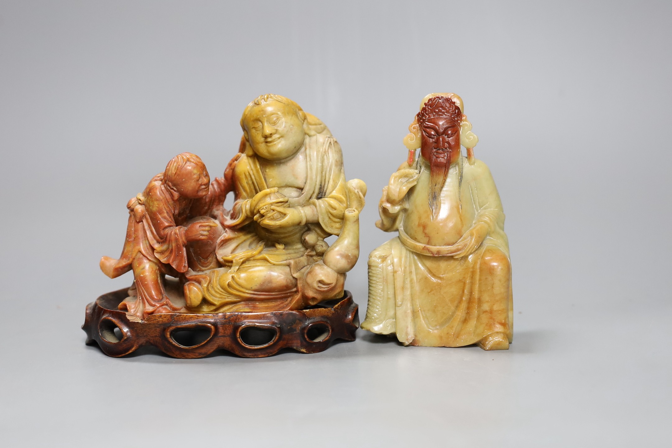 Two Chinese soapstone figures one wood stand,, widest 13 cms